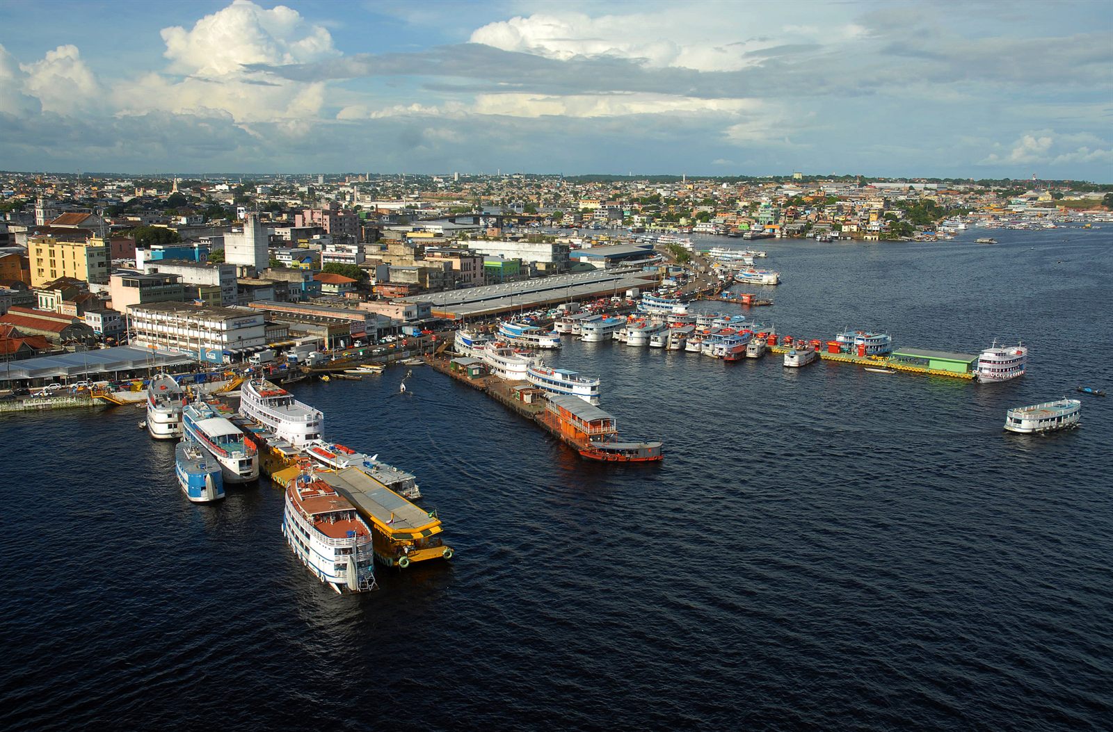Riverboats and floating docks at the busy river port of an Amazon city